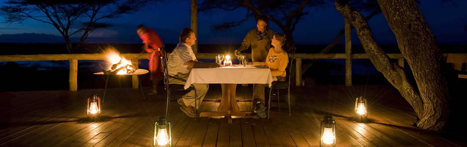 Dinner on the verandah at Lake Masek luxury tented safari camp